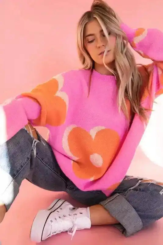 Bonbon Plus floral sweater styled in a relaxed pose with ripped jeans, highlighting soft knit and bold floral design.