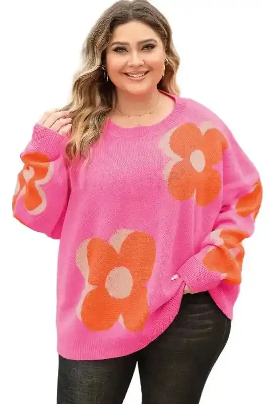 Studio shot of Bonbon Plus floral sweater on model, emphasizing bright floral print and flattering plus-size fit.