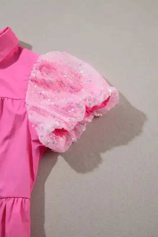Detailed view of the sequin-embellished bubble sleeve on the Bonbon Pink Shirt Dress, adding sparkle to the playful design.