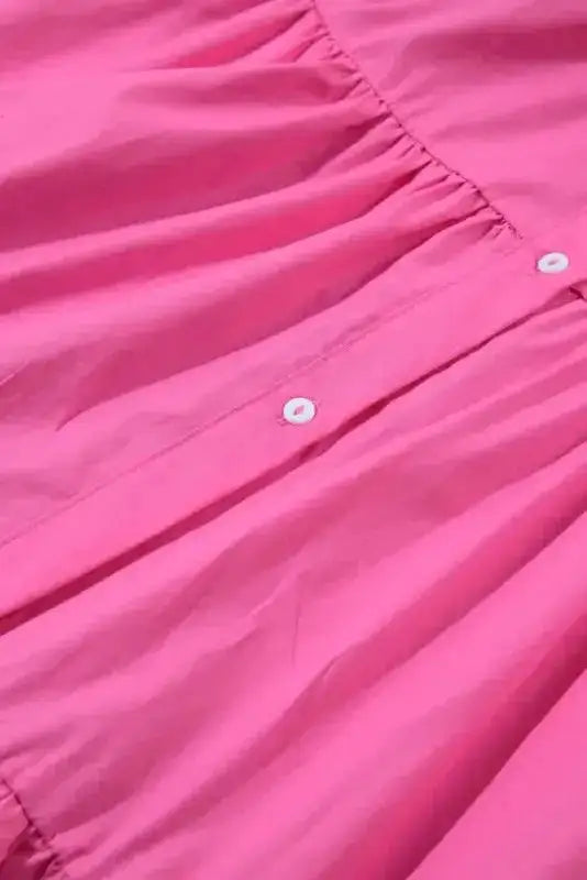 Fabric and button detail of the Bonbon Pink Sequined Shirt Dress, showing soft pink cotton and tiered ruffle construction.
