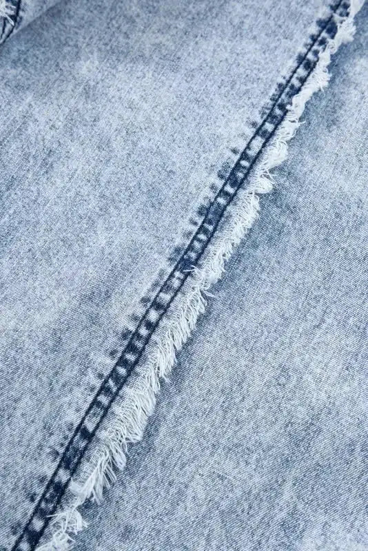 Close-up of frayed seam on Beau Blue Denim Overall, highlighting the textured finish and quality denim craftsmanship.