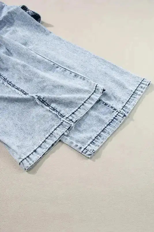 Hem detail of Beau Blue Frayed Wide Leg Denim Overall showcasing wide leg cut and raw edge finish for a trendy look.