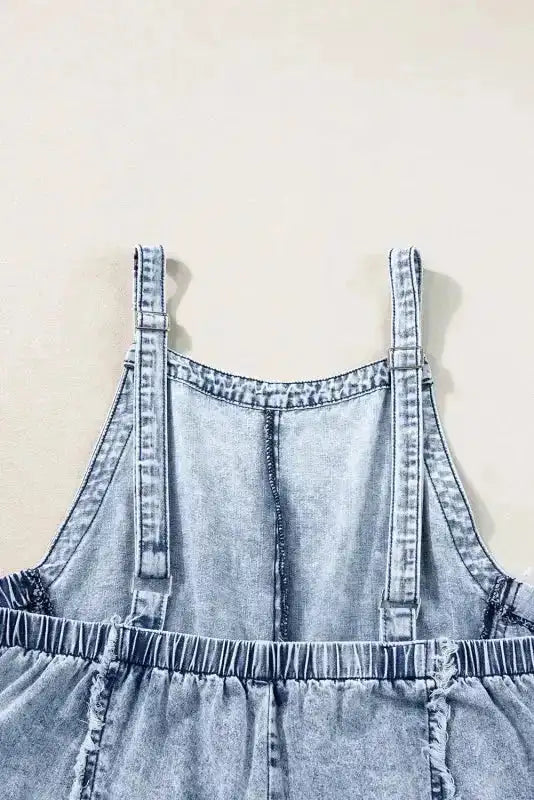 Back detail of Beau Blue Frayed Wide Leg Denim Overall with elastic waistband and adjustable straps for a custom fit.