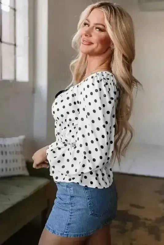 Side view of Polka Dot Bow Detail Peplum Blouse showing peplum flare and puff sleeve structure — Fashionfitz