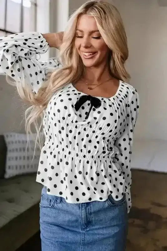 Close-up of Polka Dot Bow Detail Puff Sleeve Peplum Blouse showing bow detail and classic black polka dot on 100% polyester — Fashionfitz