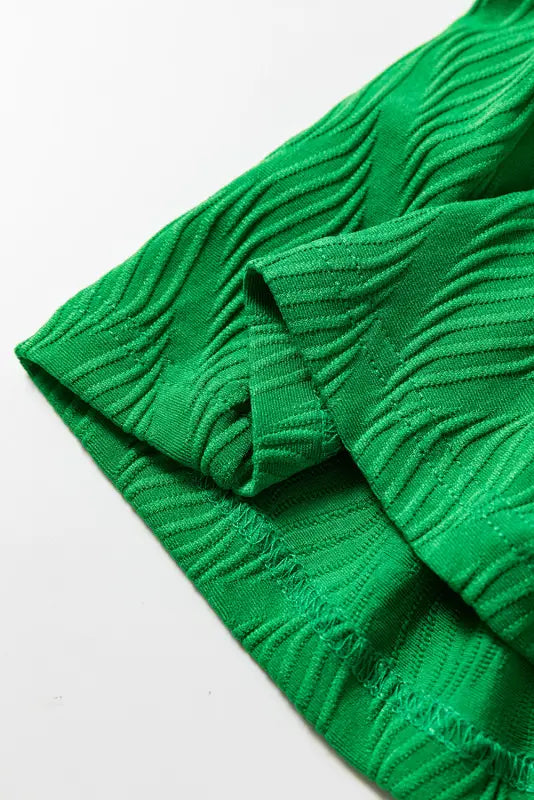 Bright green textured fabric with wavy patterns, part of the bright green co-ord shorts set