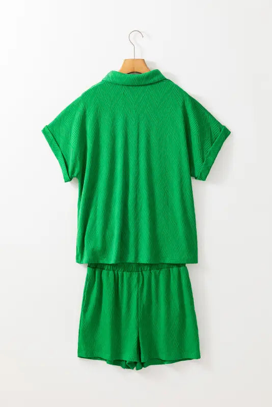 Bright green co-ord shorts set offering a relax relax vibe, displayed on a wooden hanger