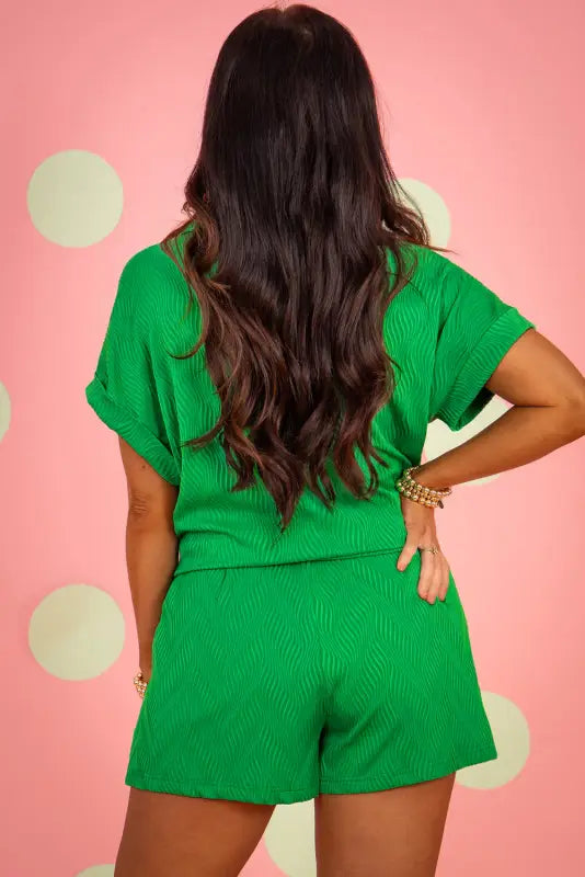 Relax in style with a bright green short-sleeved romper, perfect for a relaxed day