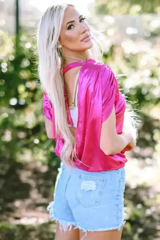 Side view of knotted backless pink blouse with ruched sleeves, styled for a fashionable Southern Belle summer look.