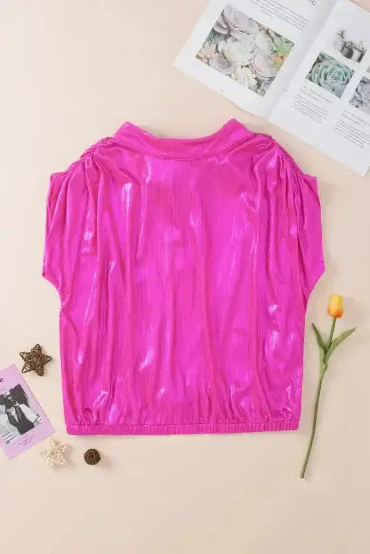 Flat lay of bright pink satin blouse front view, featuring ruched sleeves and elastic hem for a flattering fit.