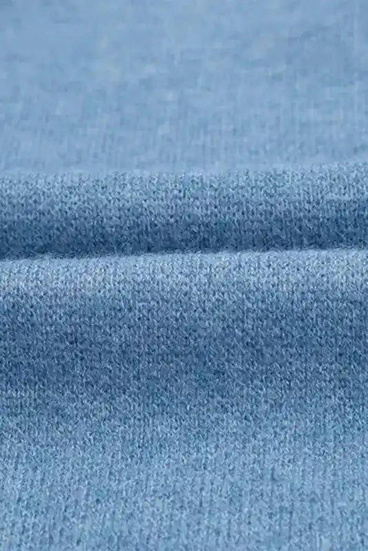 Fabric texture close-up of Brown Aztec Print Cardigan, showcasing soft blue knit material ideal for fall and winter comfort.
