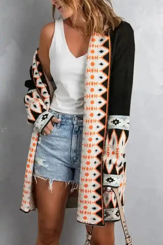 Model wearing black Brown Aztec Print Cardigan open over white tank and denim shorts, featuring vibrant Aztec trim.