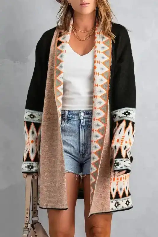 Black version of Brown Aztec Print Cardigan with orange and white tribal design, styled with denim shorts and white top.