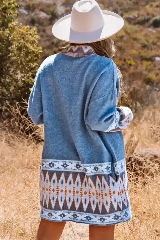 Back view of Brown Aztec Print Cardigan in blue, showcasing bold geometric Aztec design and cozy duster length for seasonal wear.