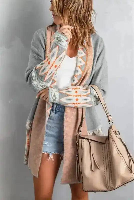 Bohemian-style Gray Aztec Print Cardigan with long sleeves and tribal detailing, paired with a neutral handbag for fall layering.