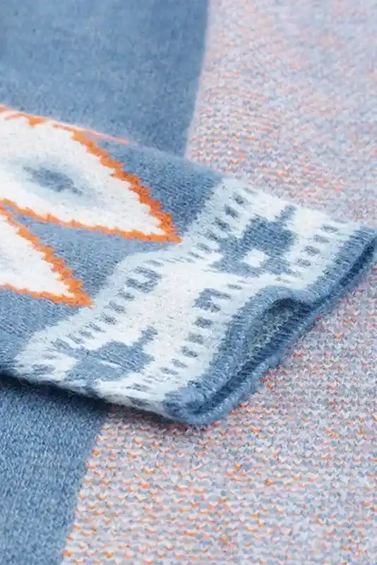 Sleeve close-up of Brown Aztec Print Cardigan, displaying bold tribal pattern and soft knit fabric in blue, white, and orange.