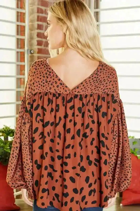 Back view of brown leopard print blouse featuring a deep V-neck and voluminous bubble sleeves, perfect for smart casual looks.