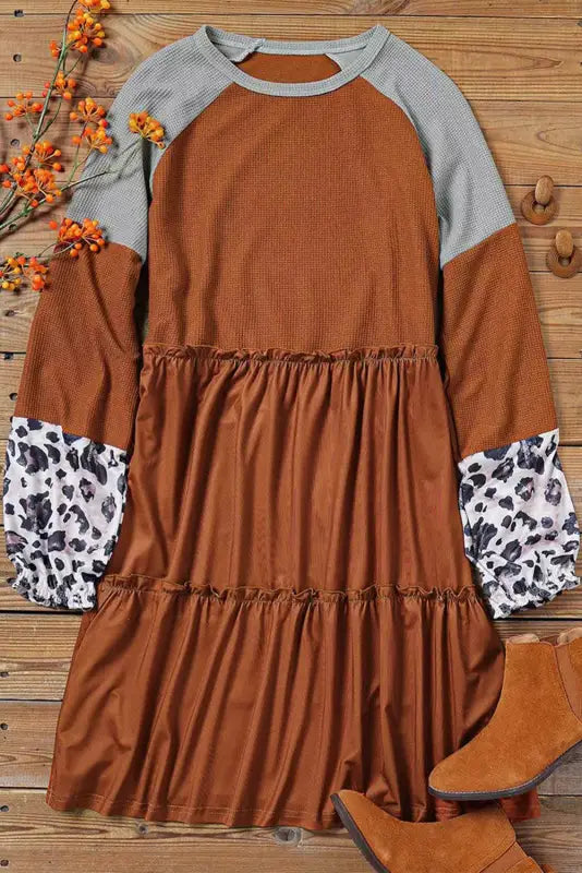 Brown waffle knit dress with rust tiers, gray raglan sleeves, and leopard print cuffs