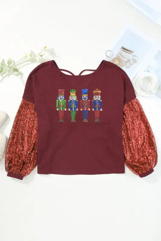 Burgundy sequined nutcracker doll contrast sleeve knit top - graphic