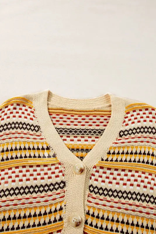 Colorful patterned buttoned cropped cardigan with v-neck, buttons, and comfortable sleeve length