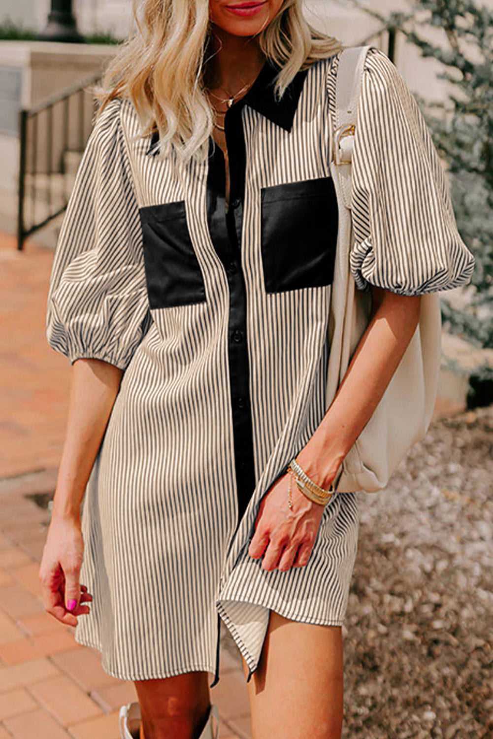 Monochrome striped puff sleeve mini dress with black collar and pockets, styled for casual summer wear with a relaxed H-line silhouette.