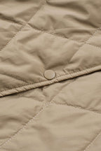 Close-up of snap button on Khaki Quilted Puffer Jacket – Hooded Snap Button Coat, emphasizing secure closure and quilted craftsmanship.
