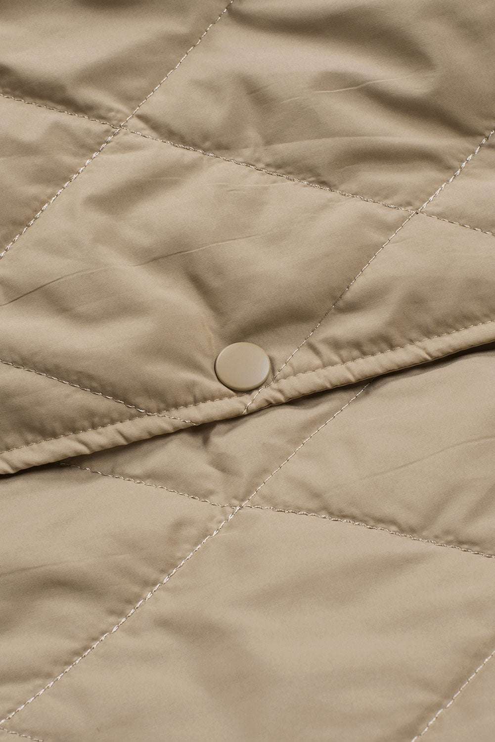 Close-up of snap button on Khaki Quilted Puffer Jacket – Hooded Snap Button Coat, emphasizing secure closure and quilted craftsmanship.