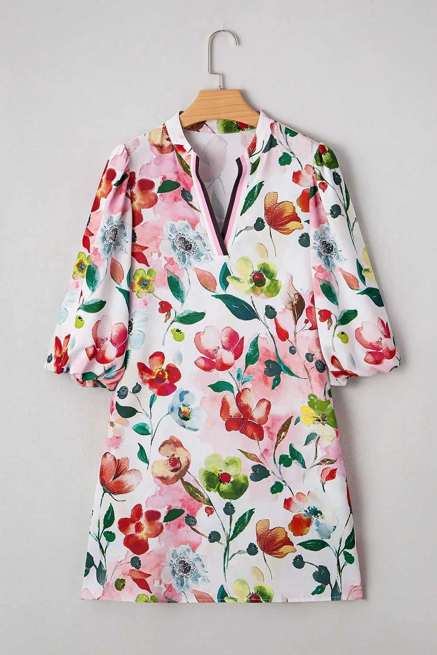 Flat lay of Floral Shift Dress - Casual Elegance on hanger, featuring bold floral print and H-line silhouette for versatile styling.