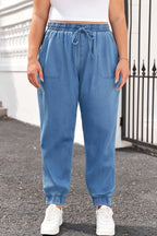 Front view of Plus Size Blue Denim Joggers with drawstring waist and oversized front pockets, perfect for casual fall outings.