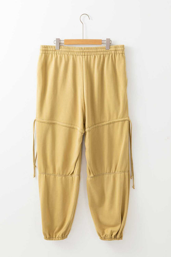 Flat lay of beige Terry Knit Drawstring Sweatpants in plus size, highlighting elastic waistband and relaxed fit for spring casual fashion.