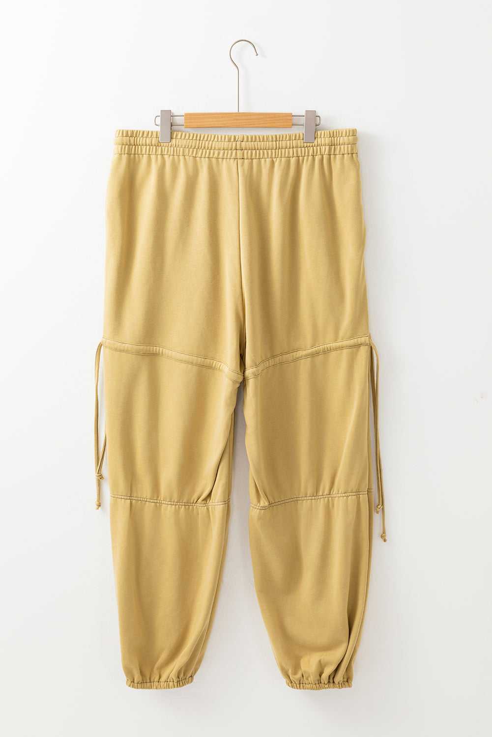 Flat lay of beige Terry Knit Drawstring Sweatpants in plus size, highlighting elastic waistband and relaxed fit for spring casual fashion.
