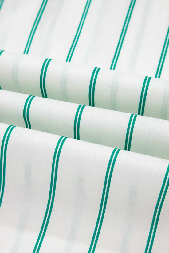 Close-up of fabric with green stripes on a white background