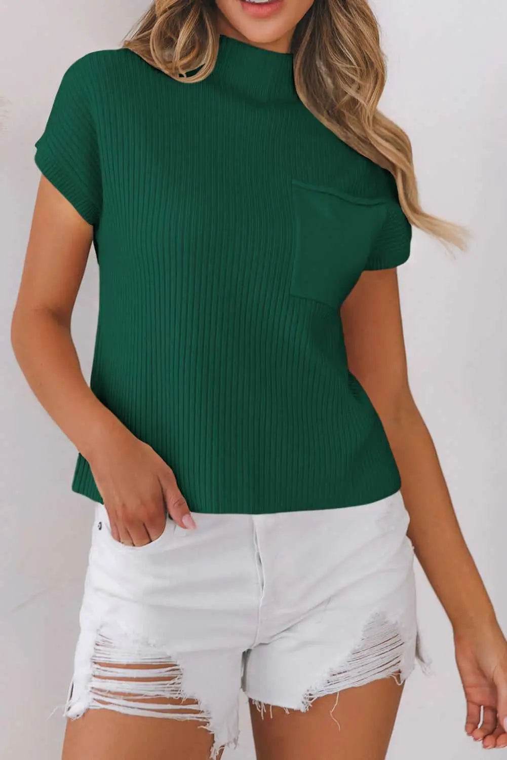 Green Ribbed Knit Short Sleeve Sweater styled with white distressed shorts, showcasing soft fabric and front pocket detail.