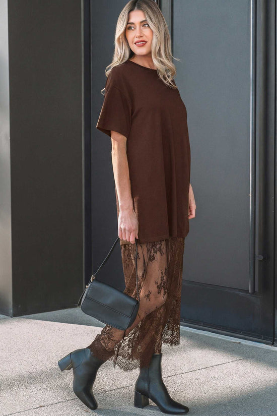 Side view of Brown Floral Lace Skirt Maxi Dress with floral lace detailing and short sleeves, styled with a black handbag and boots.