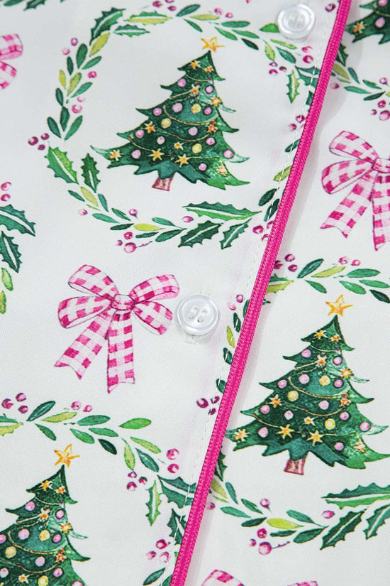Detail of button placket on Ladies White Christmas Print Velvet Trim Pyjamas with pink piping and festive tree and bow design.