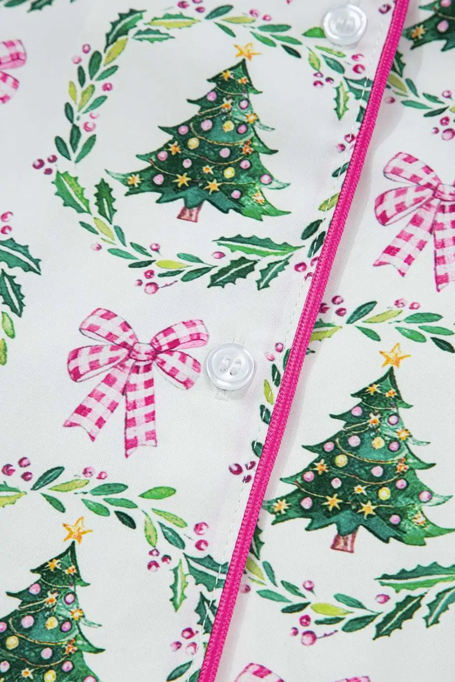 Detail of button placket on Ladies White Christmas Print Velvet Trim Pyjamas with pink piping and festive tree and bow design.
