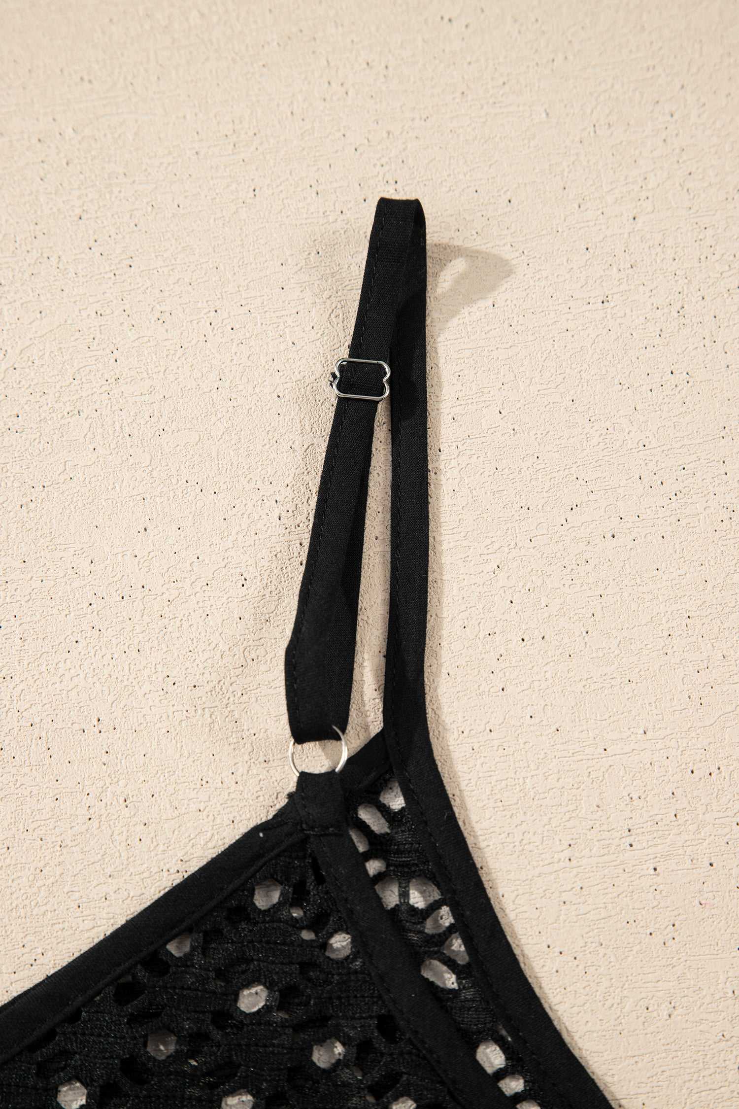 Close-up of strap detail on black crochet beach cover-up