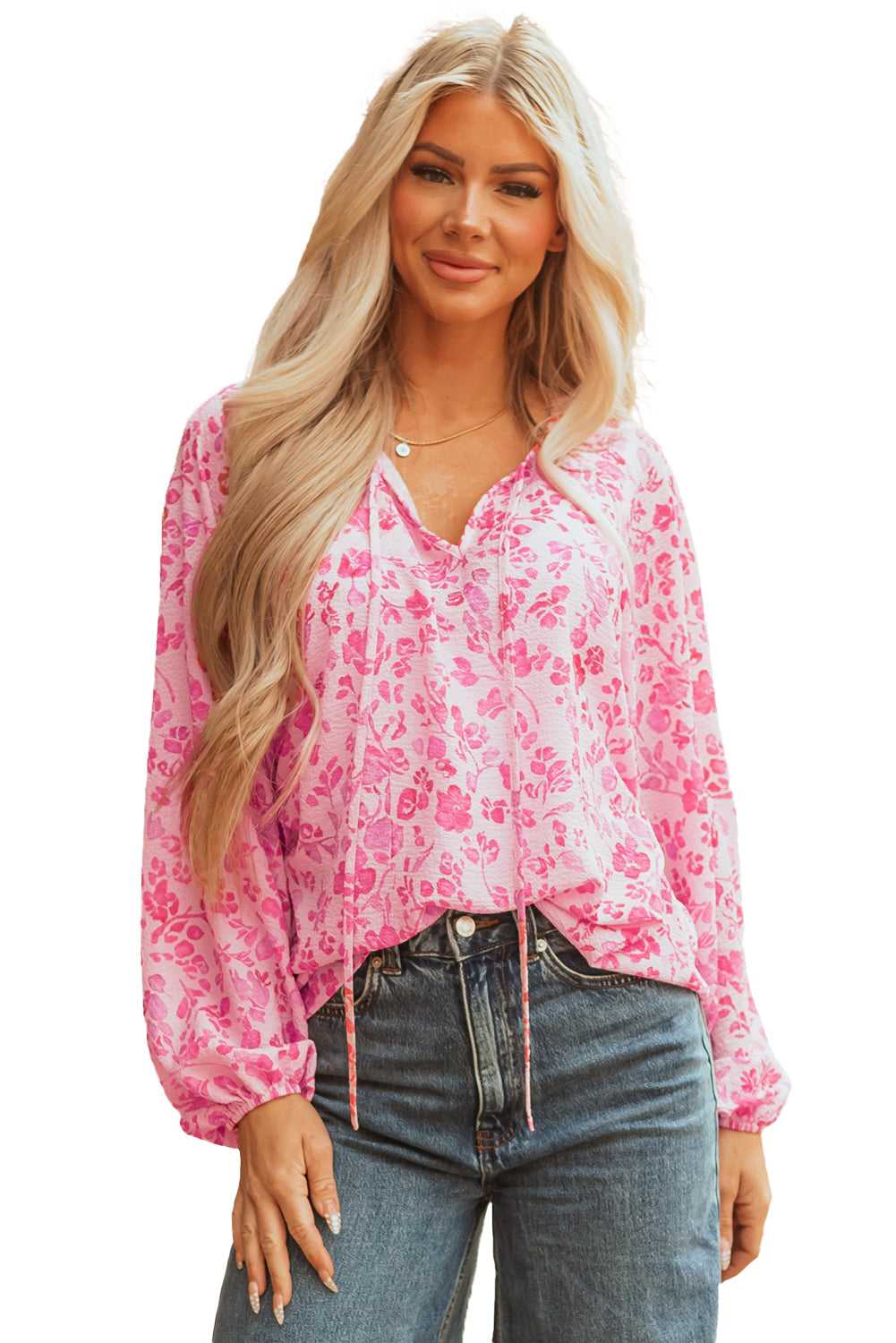 Studio shot of Pink Floral Lightweight Blouse on hanger, showcasing its pink floral design and lightweight fabric.