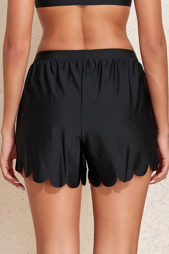 Black scalloped trim beach shorts back view