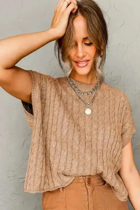 Beige Cable Knit Short Sleeve Sweater styled with layered necklaces and brown pants, perfect for transitional seasons and daily wear.