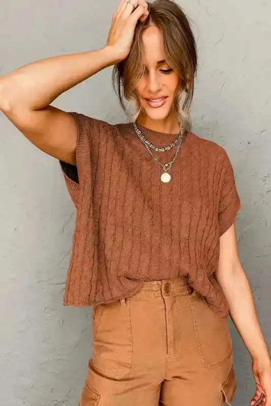 Rust brown Cable Knit Short Sleeve Sweater paired with high-waisted pants and layered jewelry, perfect for a cozy, casual look.