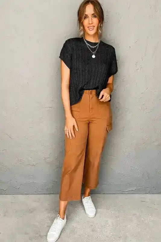 Full outfit featuring black Cable Knit Sweater - Short Sleeve Style with cropped brown pants and white sneakers for a modern casual look.