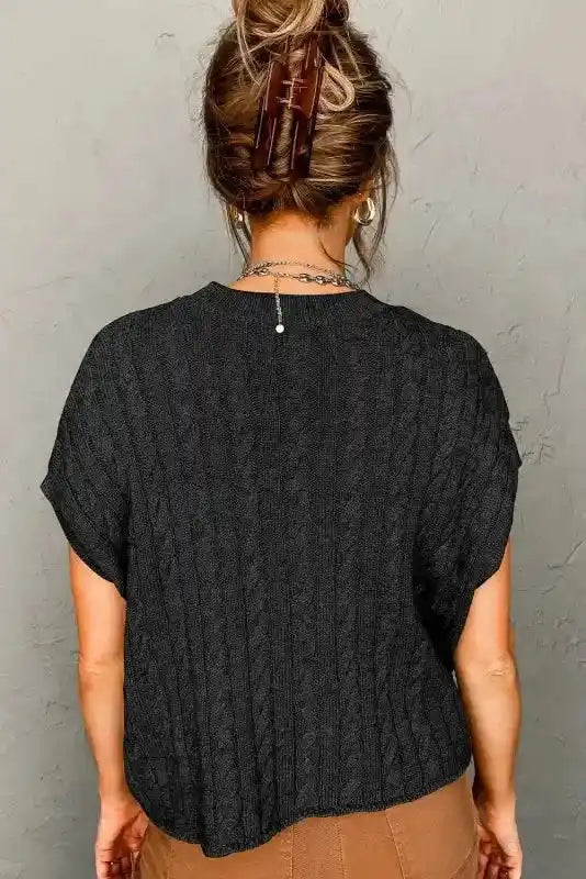 Back view of black Cable Knit Sweater - Short Sleeve Style, featuring a relaxed fit and vertical ribbed pattern for a flattering silhouette.
