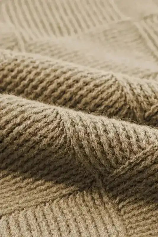 Close-up of ribbed knit texture on Camel Checkered Batwing Sleeve Sweater, highlighting soft and warm fabric quality.