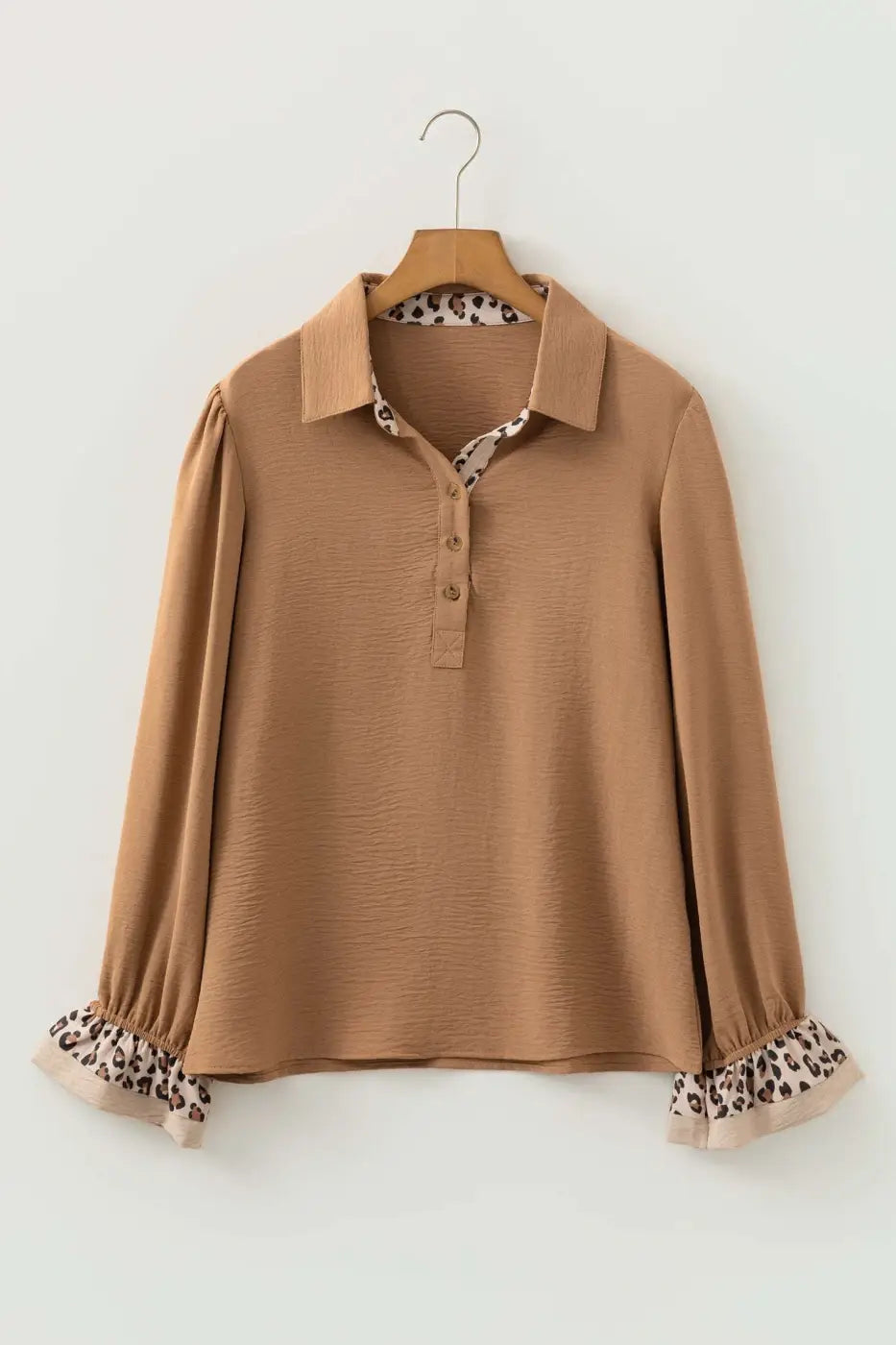 Flat lay of Camel Leopard Fusion Polo Blouse showing full design with leopard print collar and ruffle sleeve cuffs for a bold casual style.
