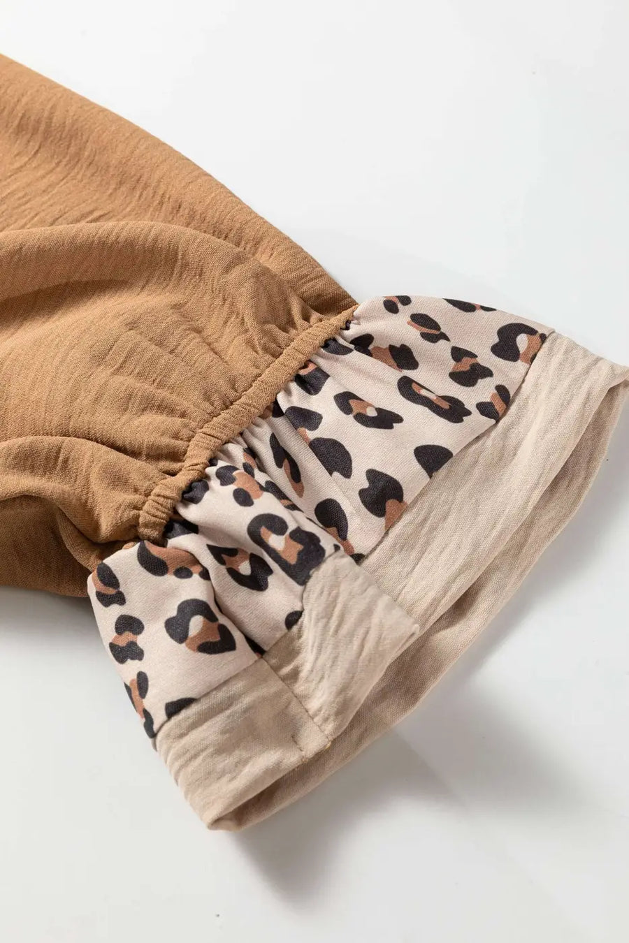 Close-up of ruffled sleeve on Camel Leopard Fusion Ruffle Sleeve Button Blouse showing leopard print cuff patchwork detail — Fashionfitz