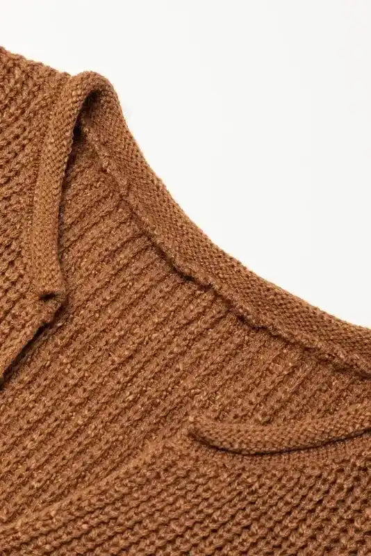 Close-up of V-neck detail on Camel Knit Dress - Short Sleeve Shift Fit. Ribbed knit texture highlights quality craftsmanship.