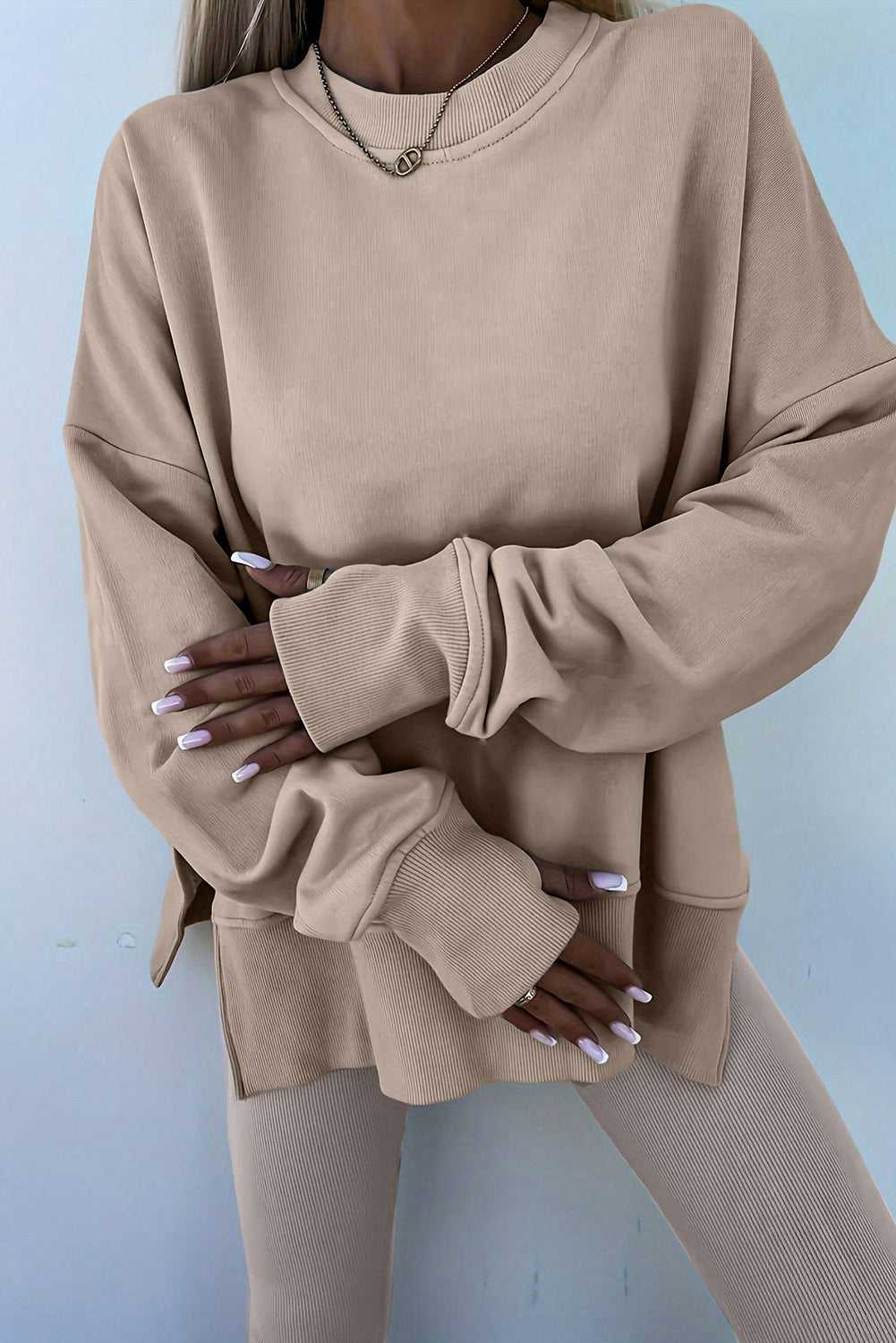Close-up of beige Oversized Sweatshirt and Leggings Matching Set, highlighting the soft fabric and oversized sleeves for a comfy lounge look.