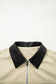 Beige jacket with black collar on a white background