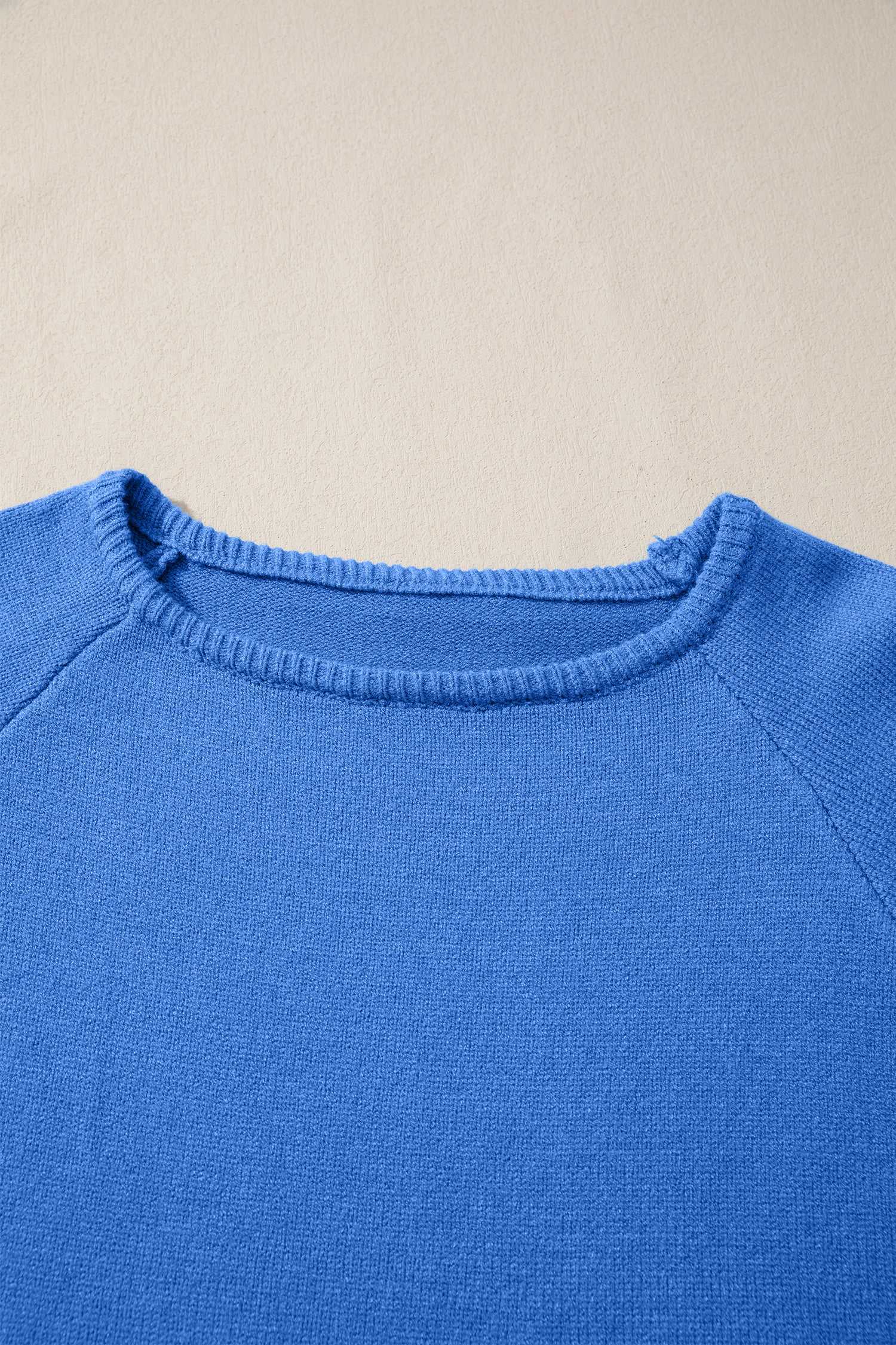 Close-up of blue Bell Sleeve Loose Knit Jumper neckline showing fine ribbed detailing and soft knit texture.